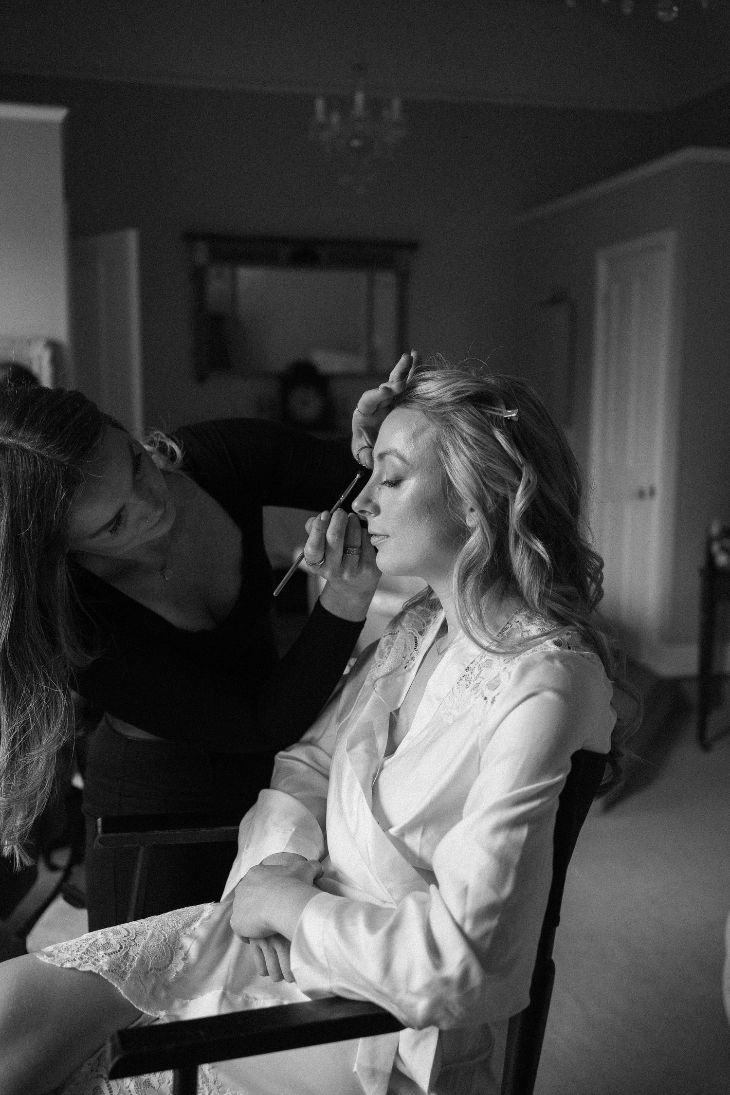 Black and white wedding preparation photos showing quiet moments before the ceremony.