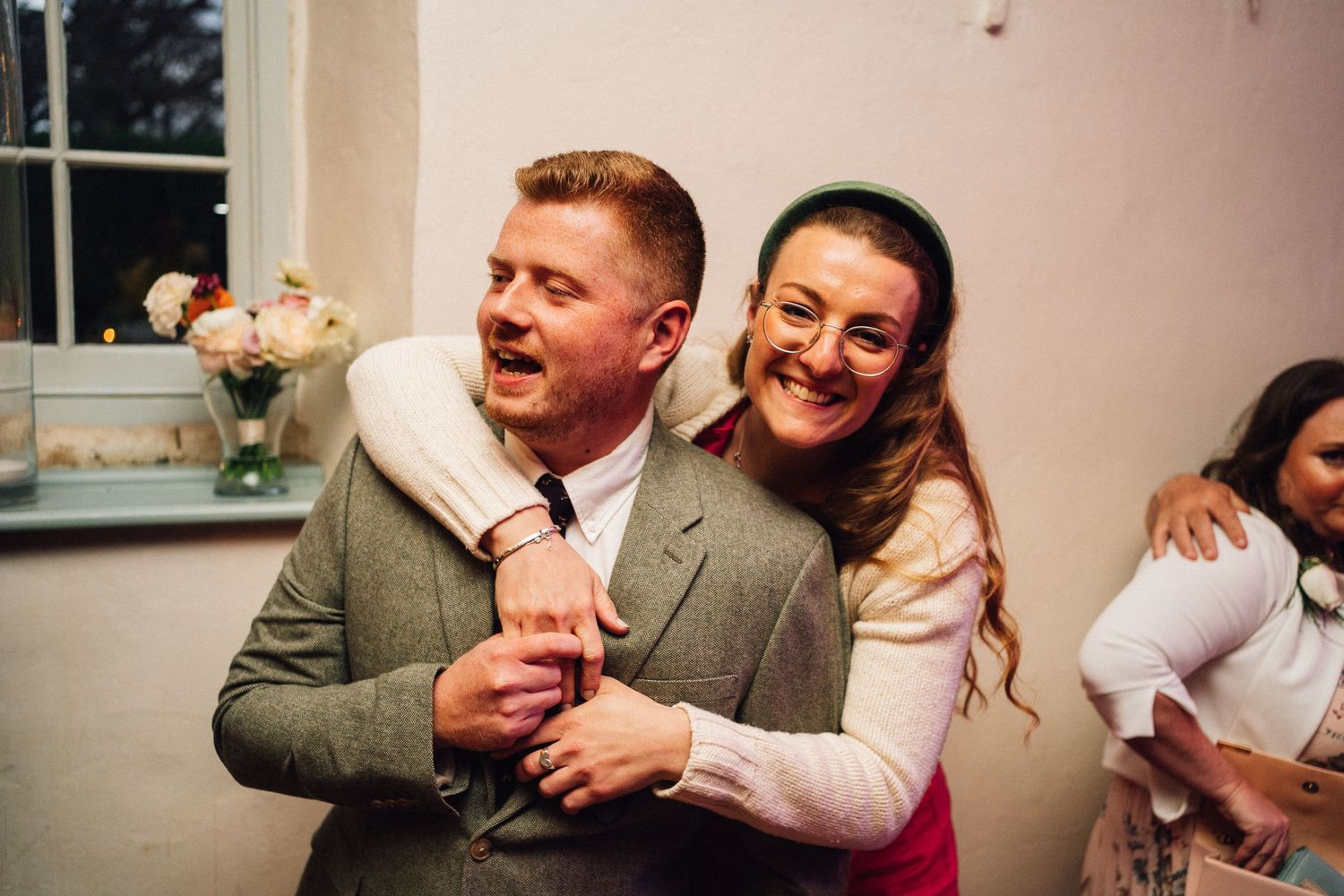 Candid moment of laughter and celebration at a wedding reception.