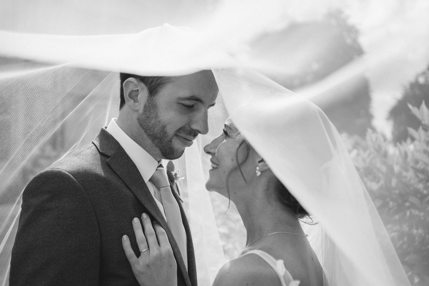 Close-up black and white wedding photography moments captured during an outdoor ceremony.