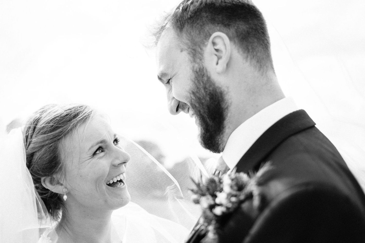 Black and white intimate wedding portraits capturing candid moments.
