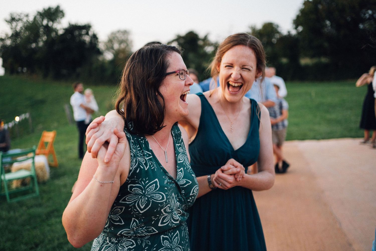 People enjoying a lively outdoor gathering in a park with casual summer attire and natural lighting.