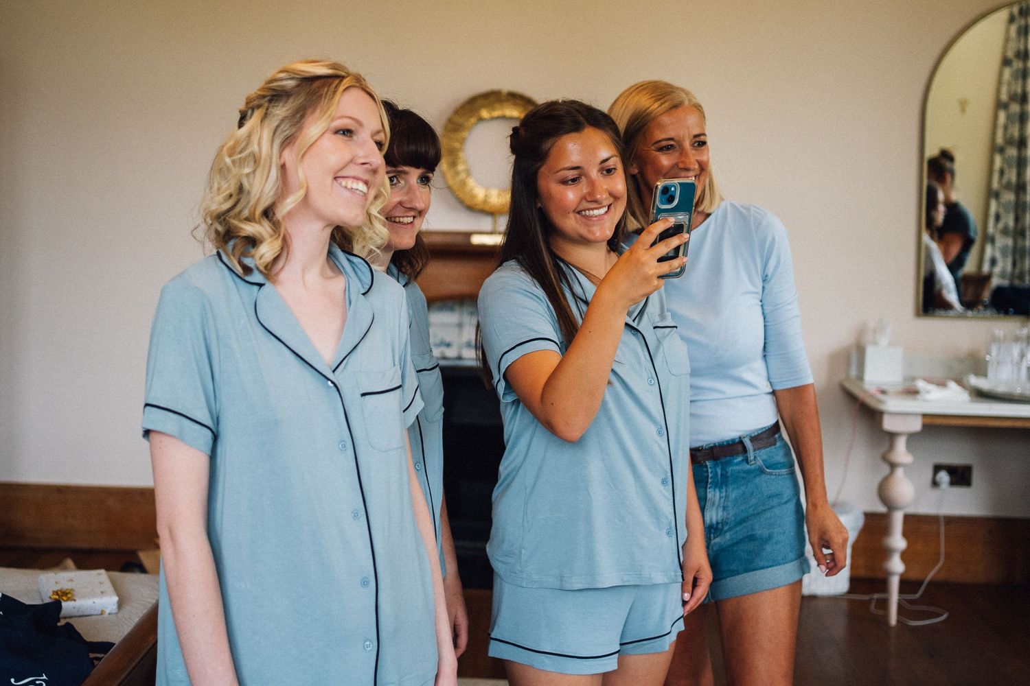 Healthcare workers in light blue scrubs share joyful moments while working together in a medical setting.