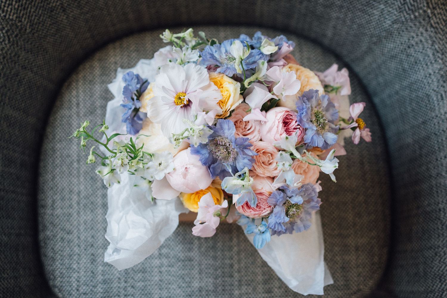 Delicate floral arrangements in pastel colors with roses, hydrangeas and greenery displayed in circular frames.