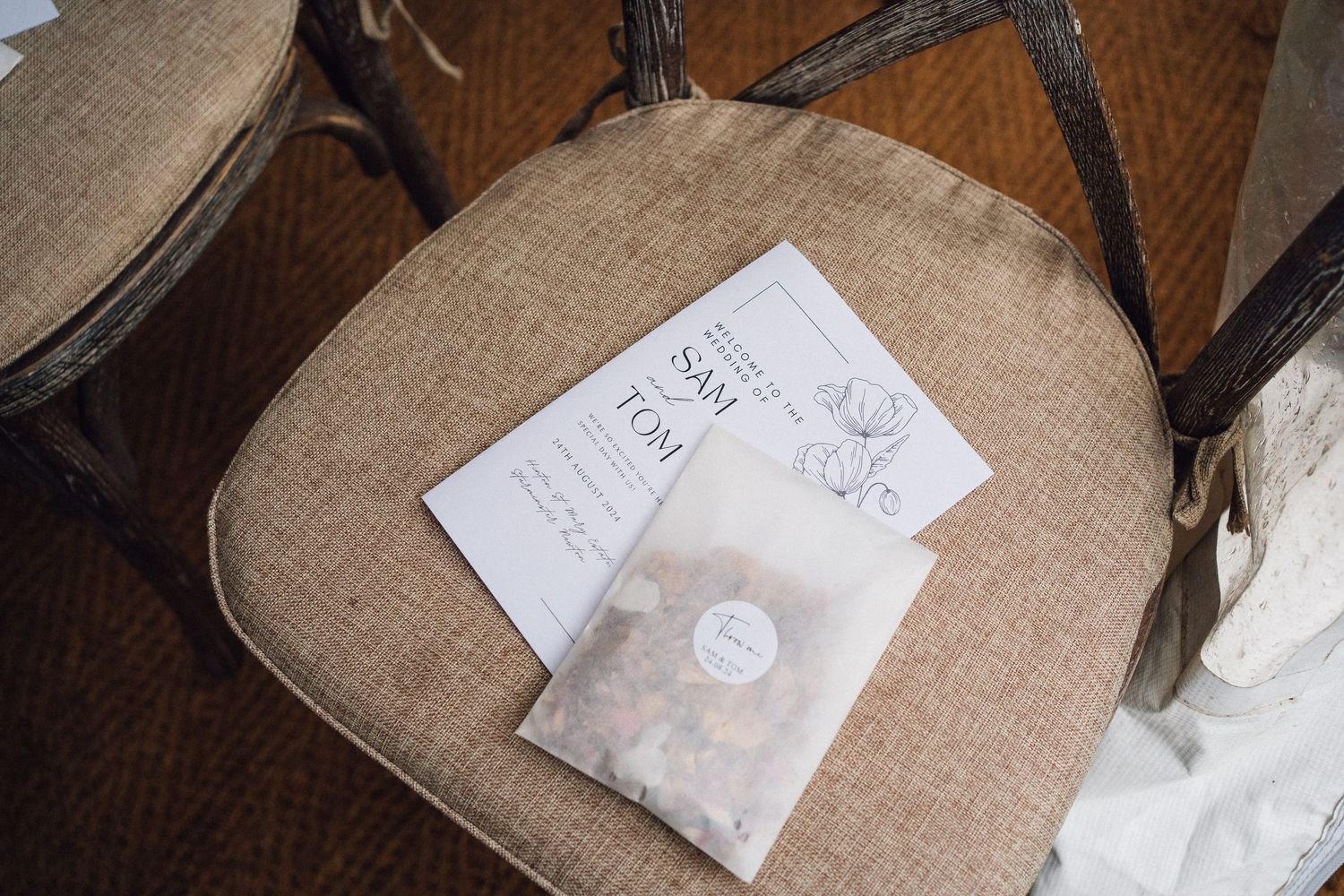 Close-up details of wedding ring pillows with handwritten notes on burlap fabric.