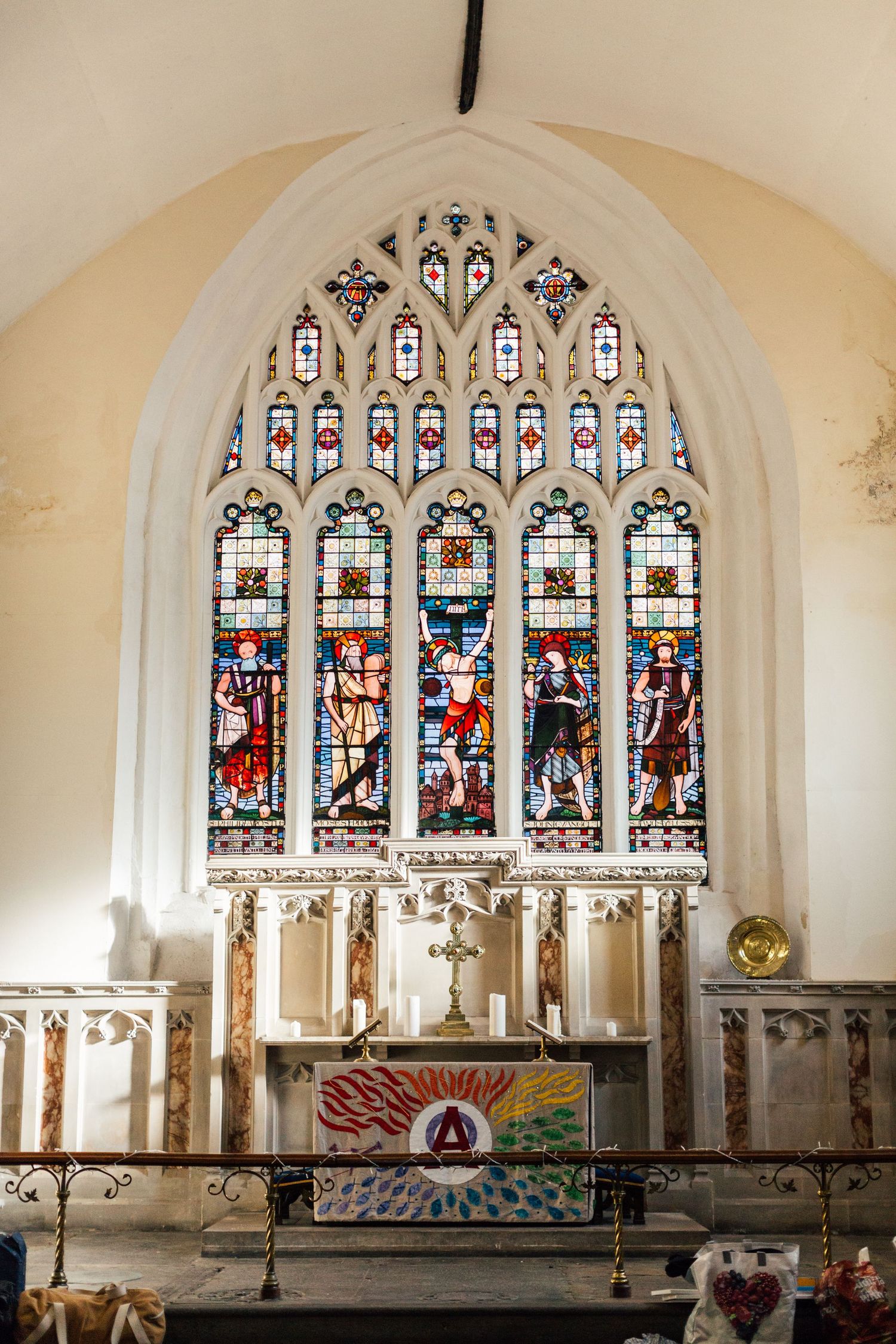 Beautiful stained glass window and altar in historic church interior.