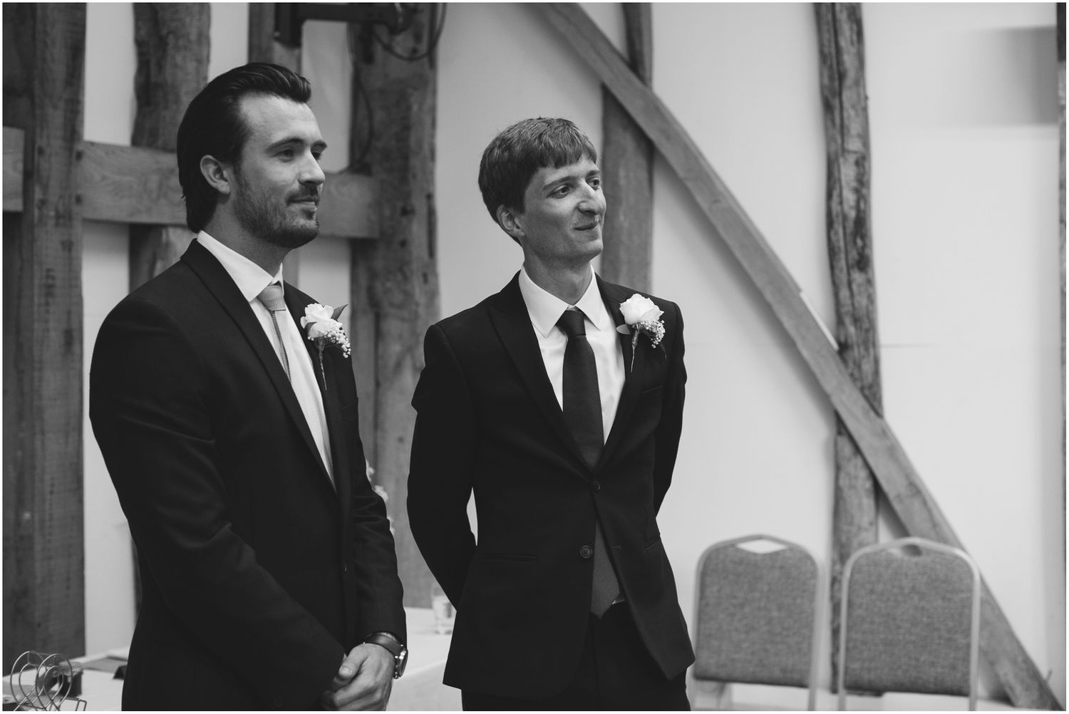Black and white photos of groomsmen sharing emotional moments.