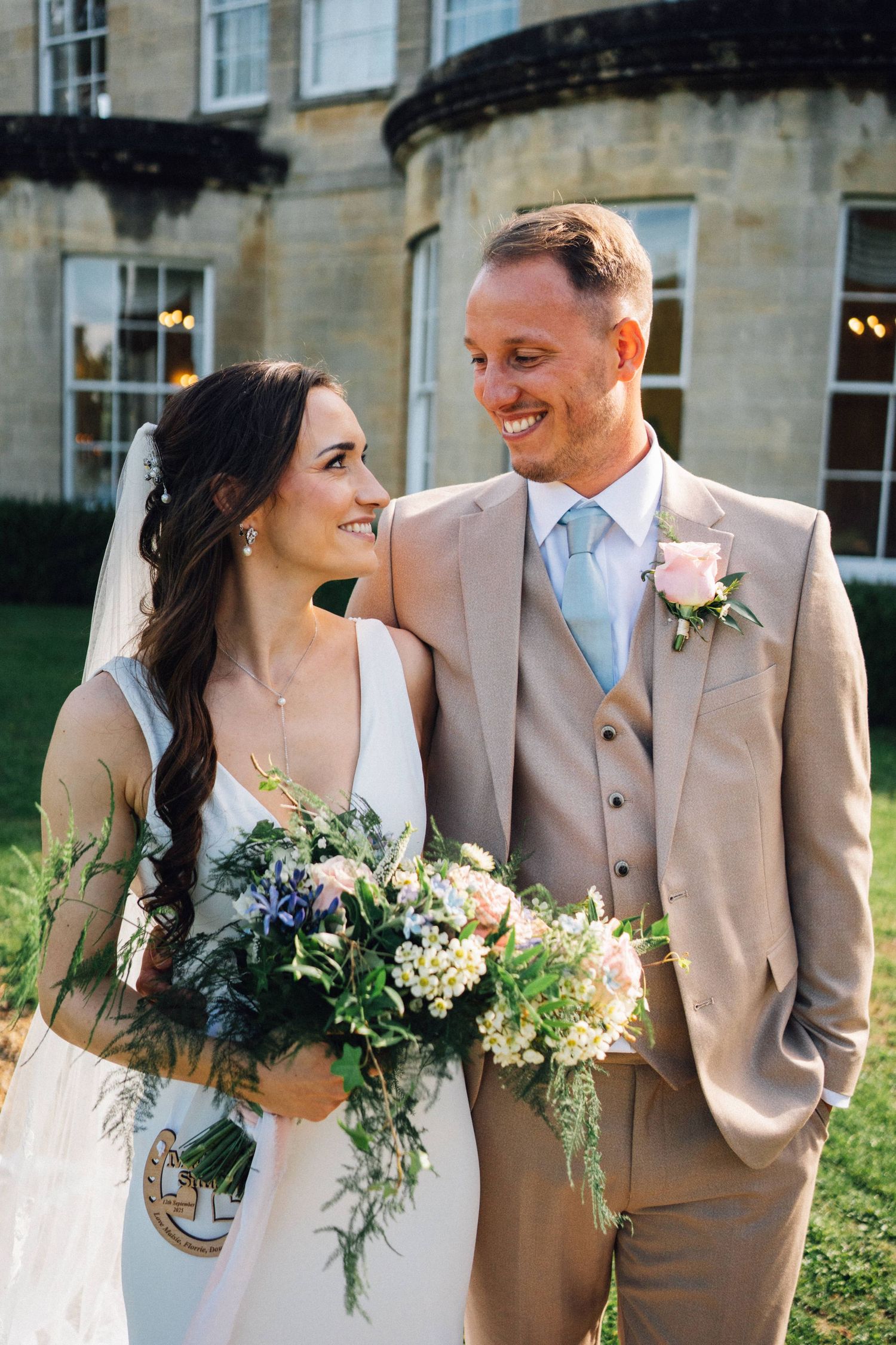 Bride and groom share intimate moments in outdoor garden setting with soft natural lighting.