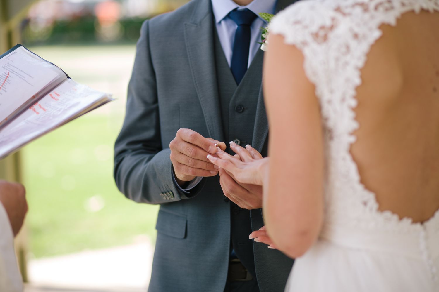 Close-up shots of wedding ceremony moments with lace dress details.