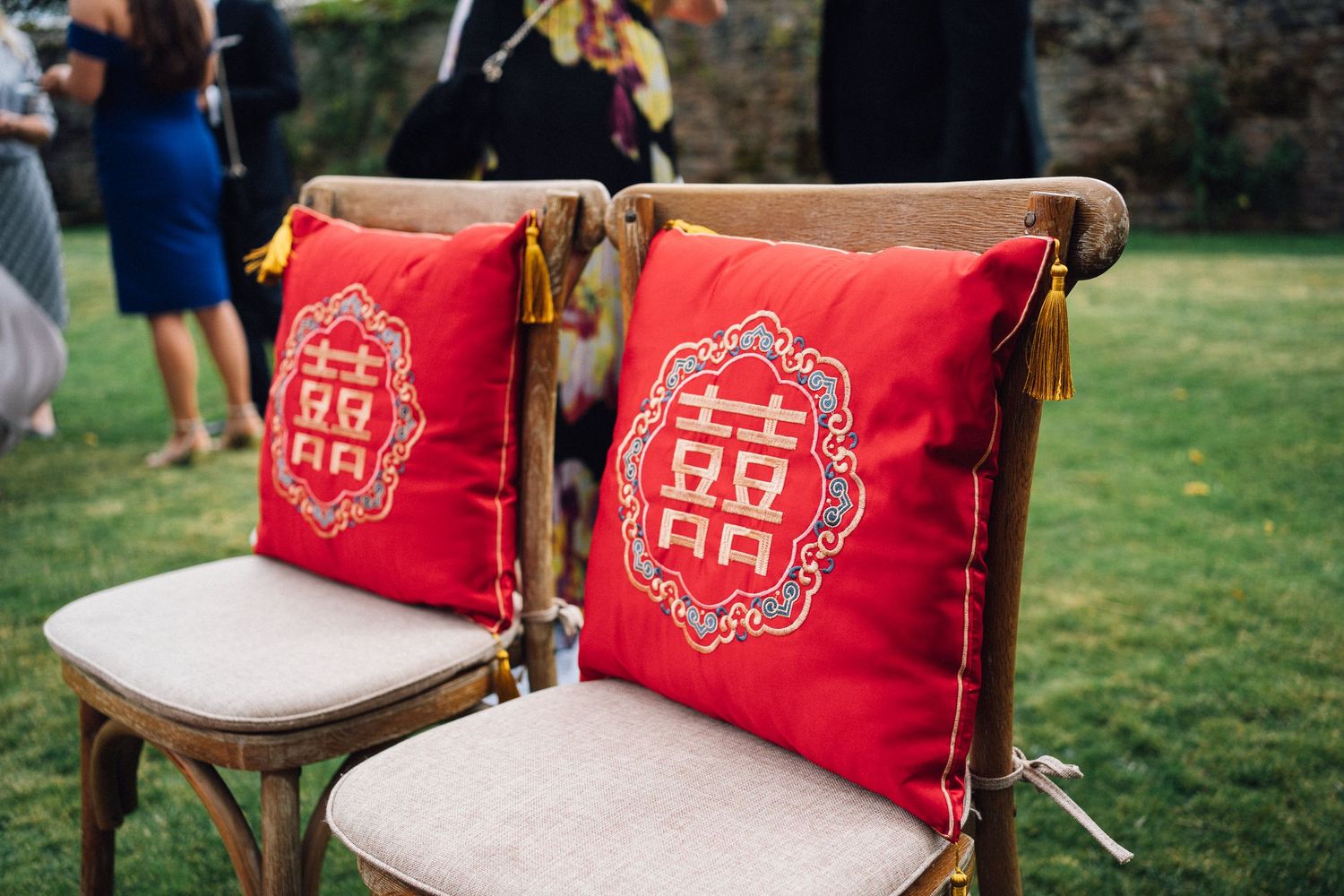 Traditional Chinese tea ceremony setup with red double happiness pillows and decorative elements.