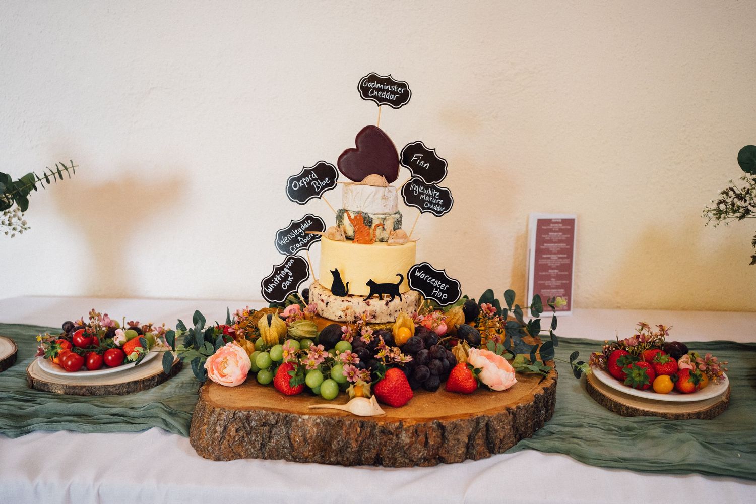 Rustic wooden table decorated with seasonal fall decor including pumpkins, berries, and autumn foliage.
