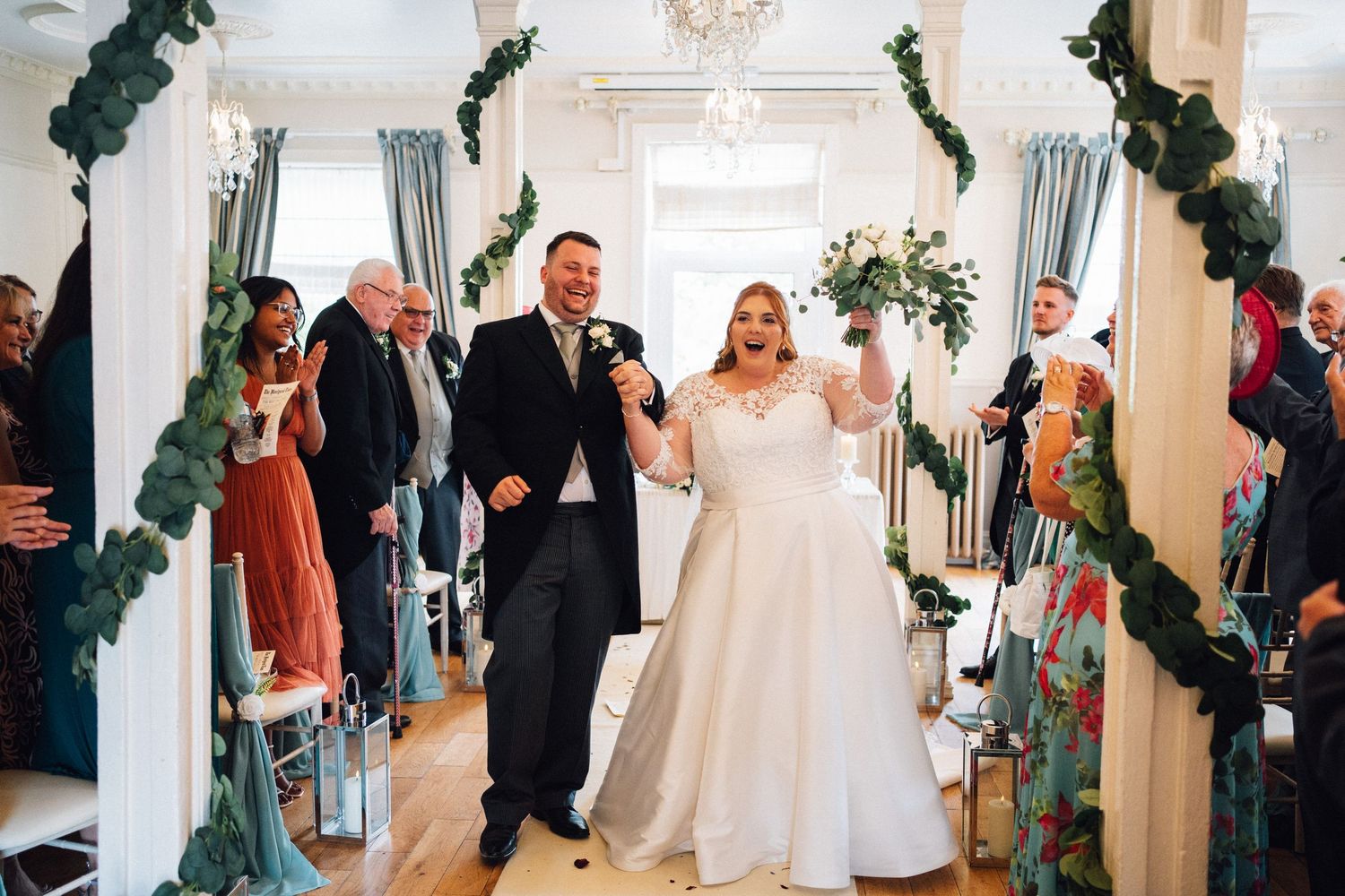 Wedding ceremony guests stand in line to celebrate the newlyweds during a traditional receiving line.
