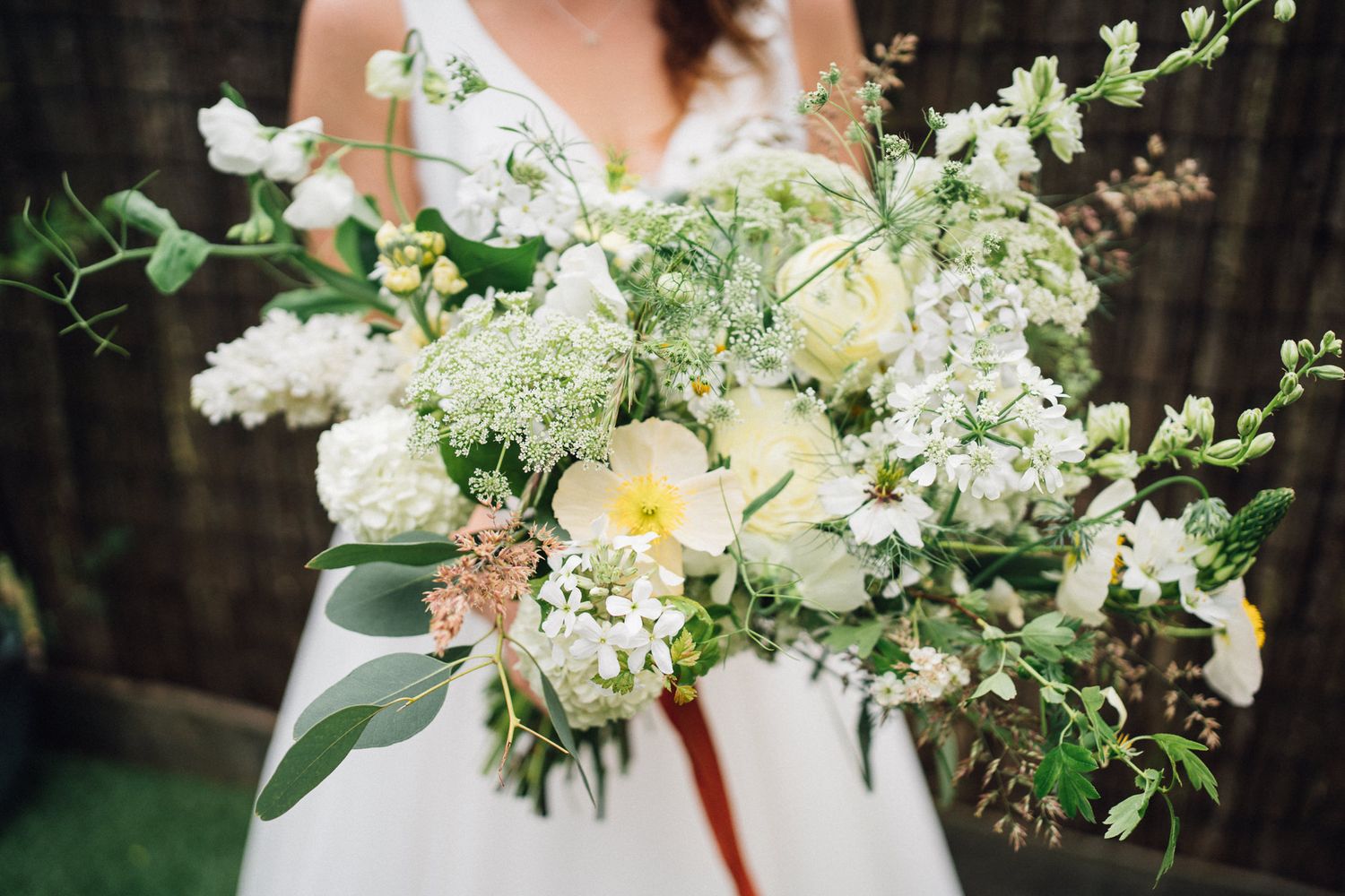 Elegant white and green floral wedding bouquet with delicate blooms.