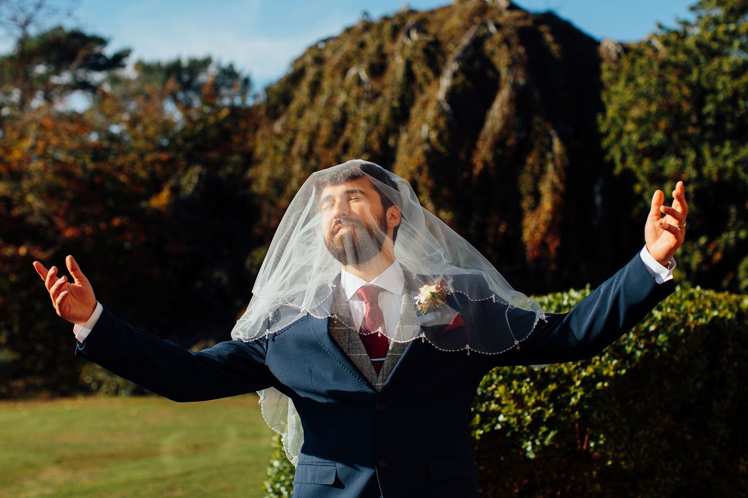 Joyful celebration poses captured against a backdrop of autumn foliage.