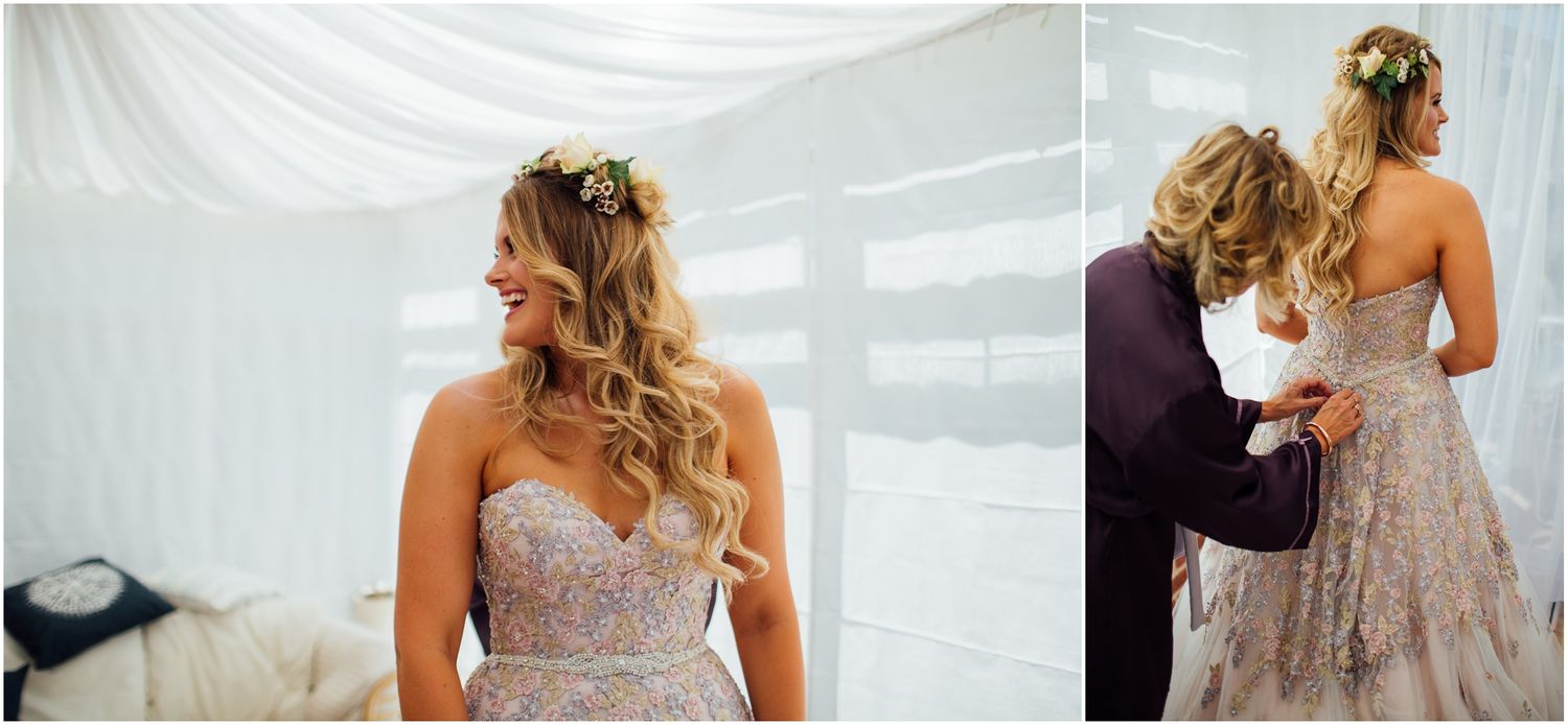 Close-up of a detailed beaded wedding dress bodice and flowing curled hairstyle in a white draped room.