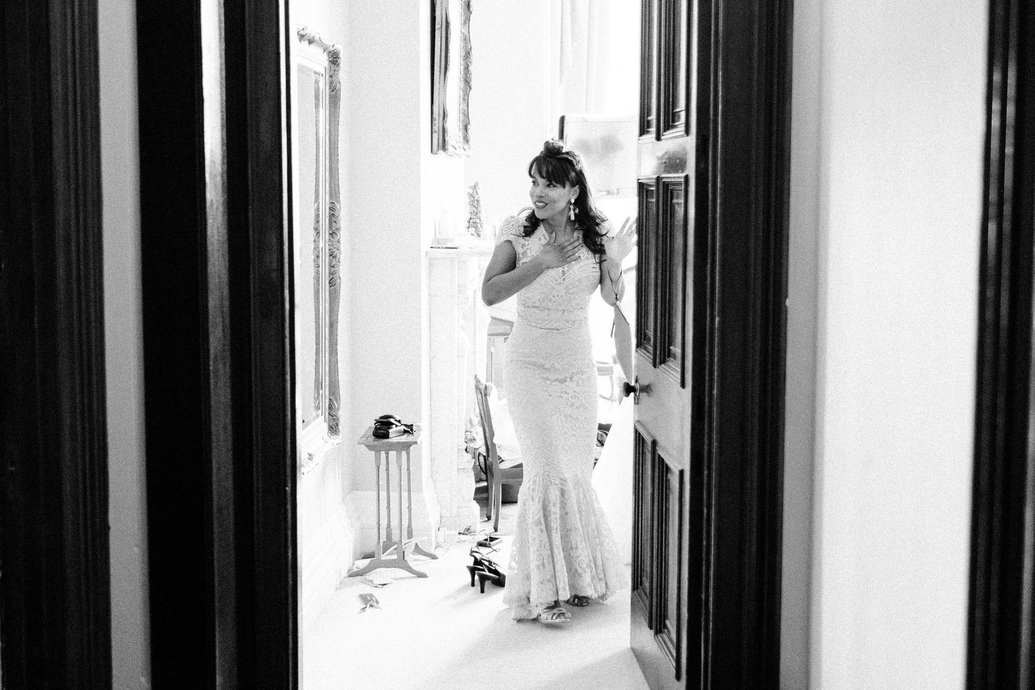 Black and white photo of elegant hallway with dramatic lighting and shadows.