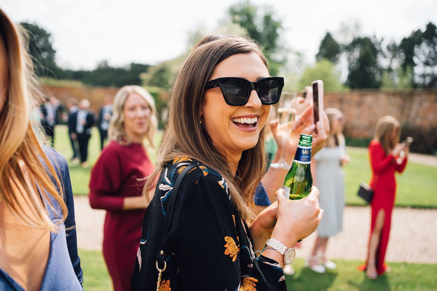 Wedding guests enjoying drinks and conversation during outdoor cocktail hour.