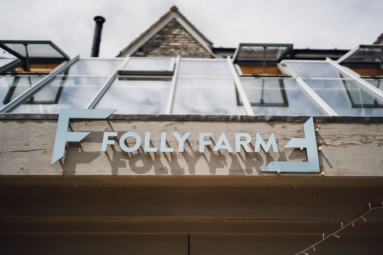Exterior signage of a wedding venue against a cloudy sky.