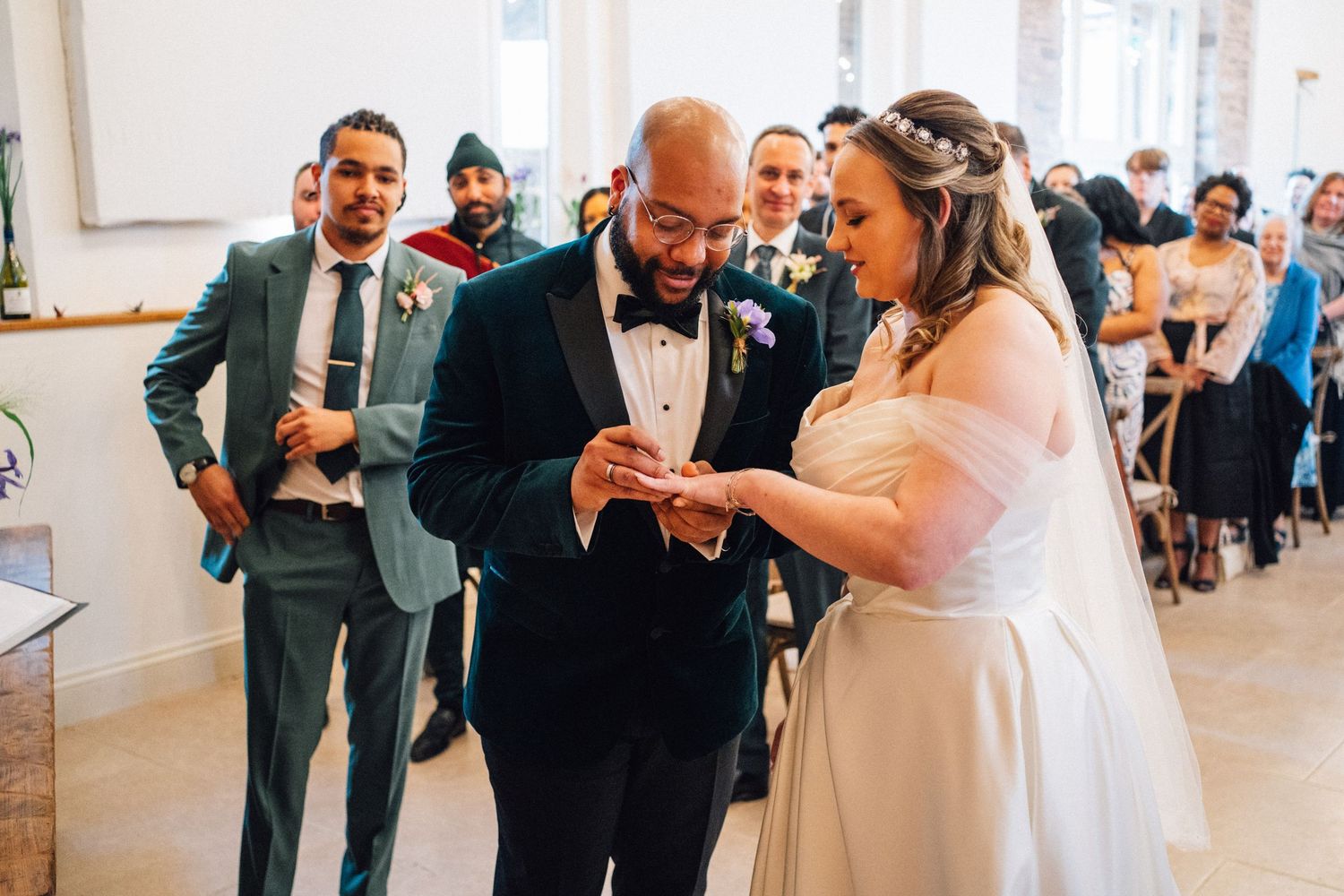 A wedding party shares joyful moments during the reception as they celebrate with drinks and laughter.
