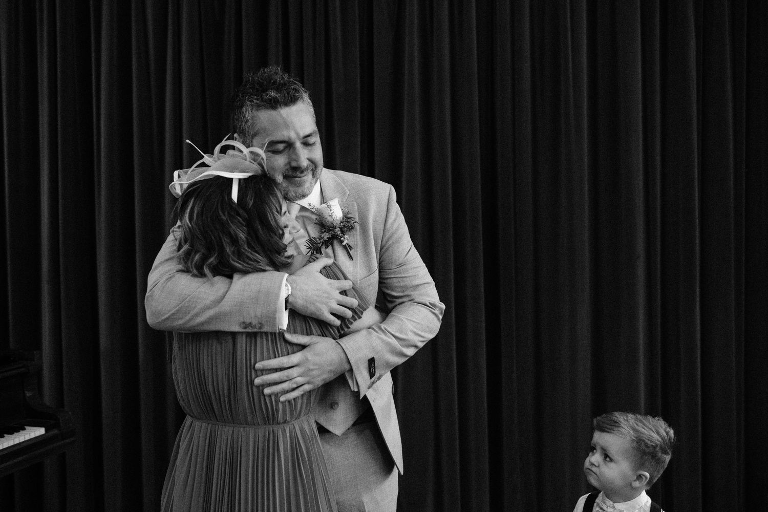 An emotional black and white moment captured during a wedding celebration.