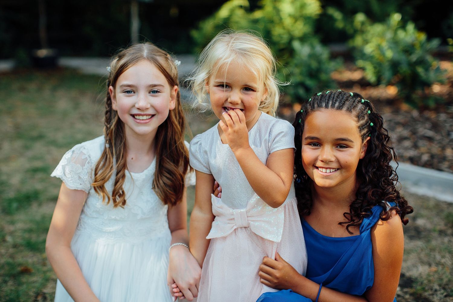 Group of young attendees smiling and enjoying themselves at a summer outdoor event.