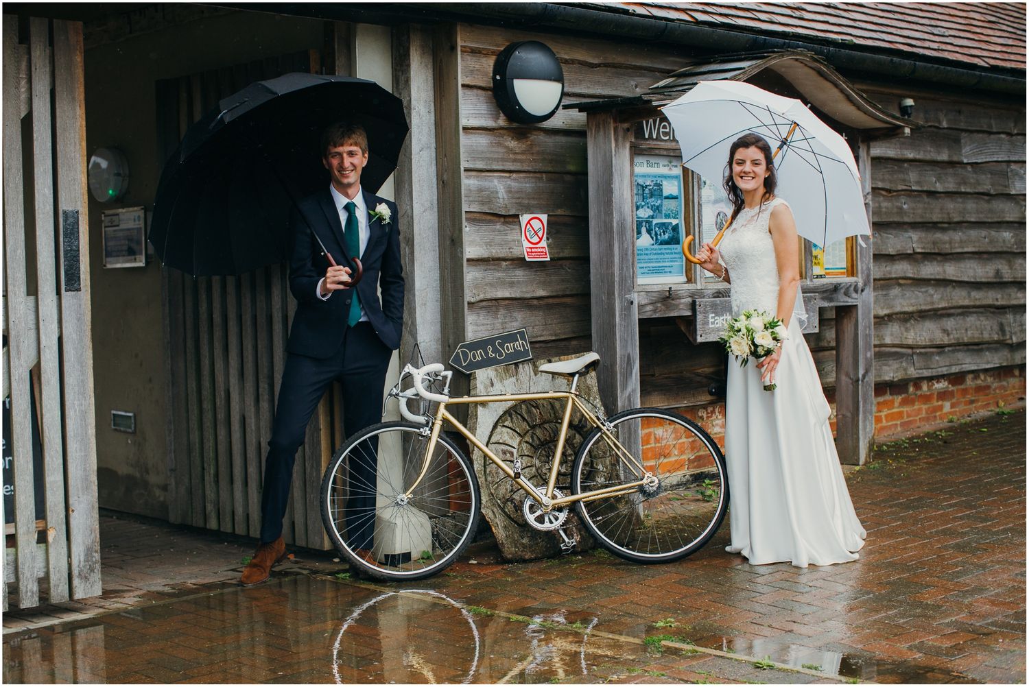 Wedding venue exterior with vintage bicycle decorations and rustic wooden buildings.