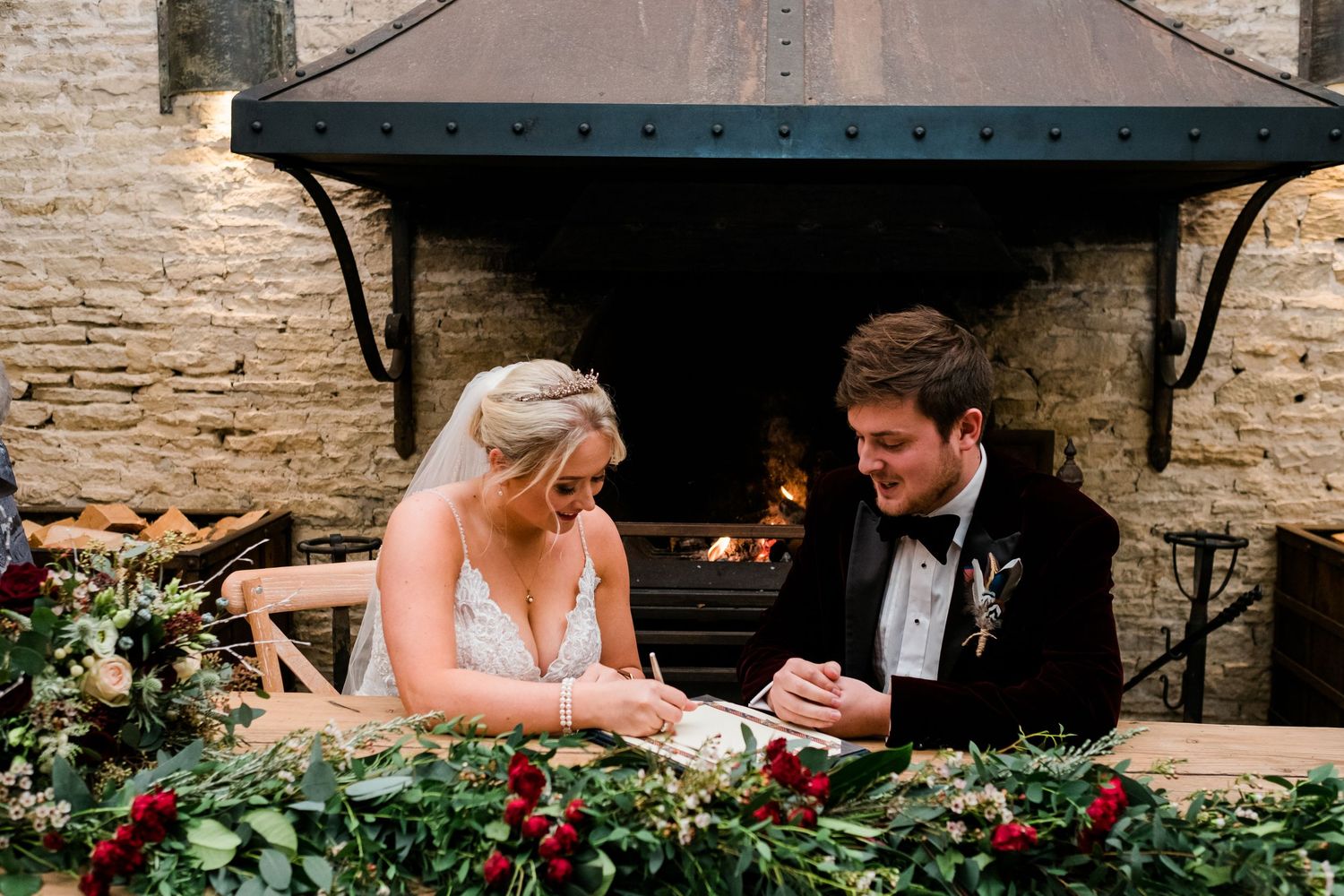 Wedding celebration scene with decorative flowers and rustic stone architecture.