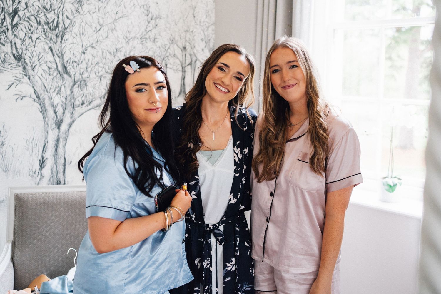 Group photo showing bridesmaids in casual attire during wedding preparations.
