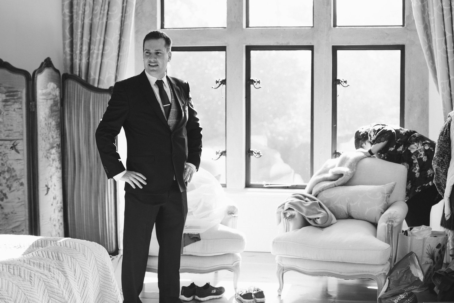 A black and white photo montage shows people in formal attire posing in various interior settings.