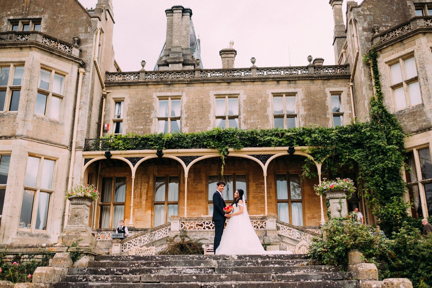 Panoramic view of a grand historic estate with stone facade and classic architecture.