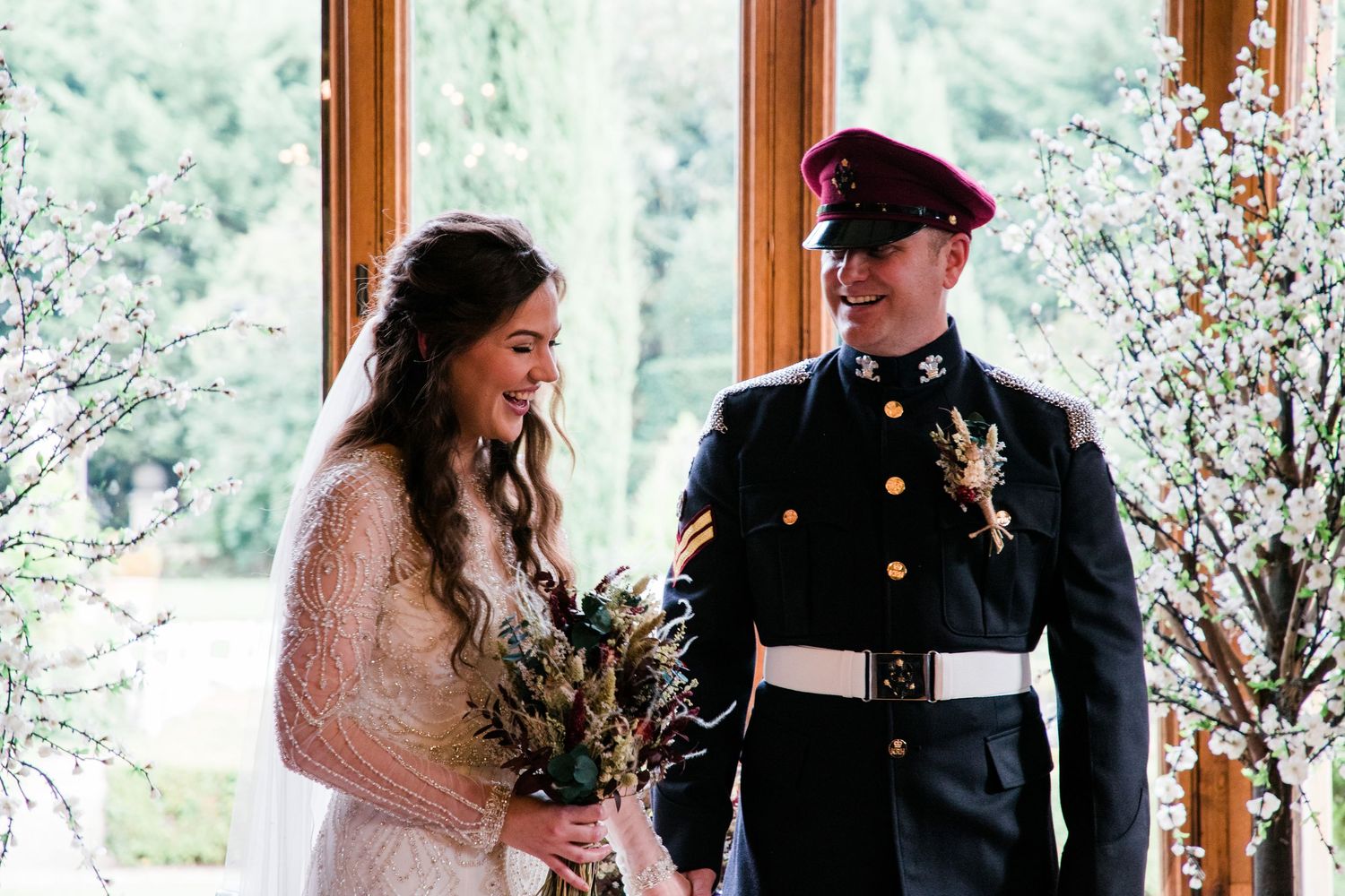 Wedding celebration in a bright indoor venue with natural light streaming through windows.