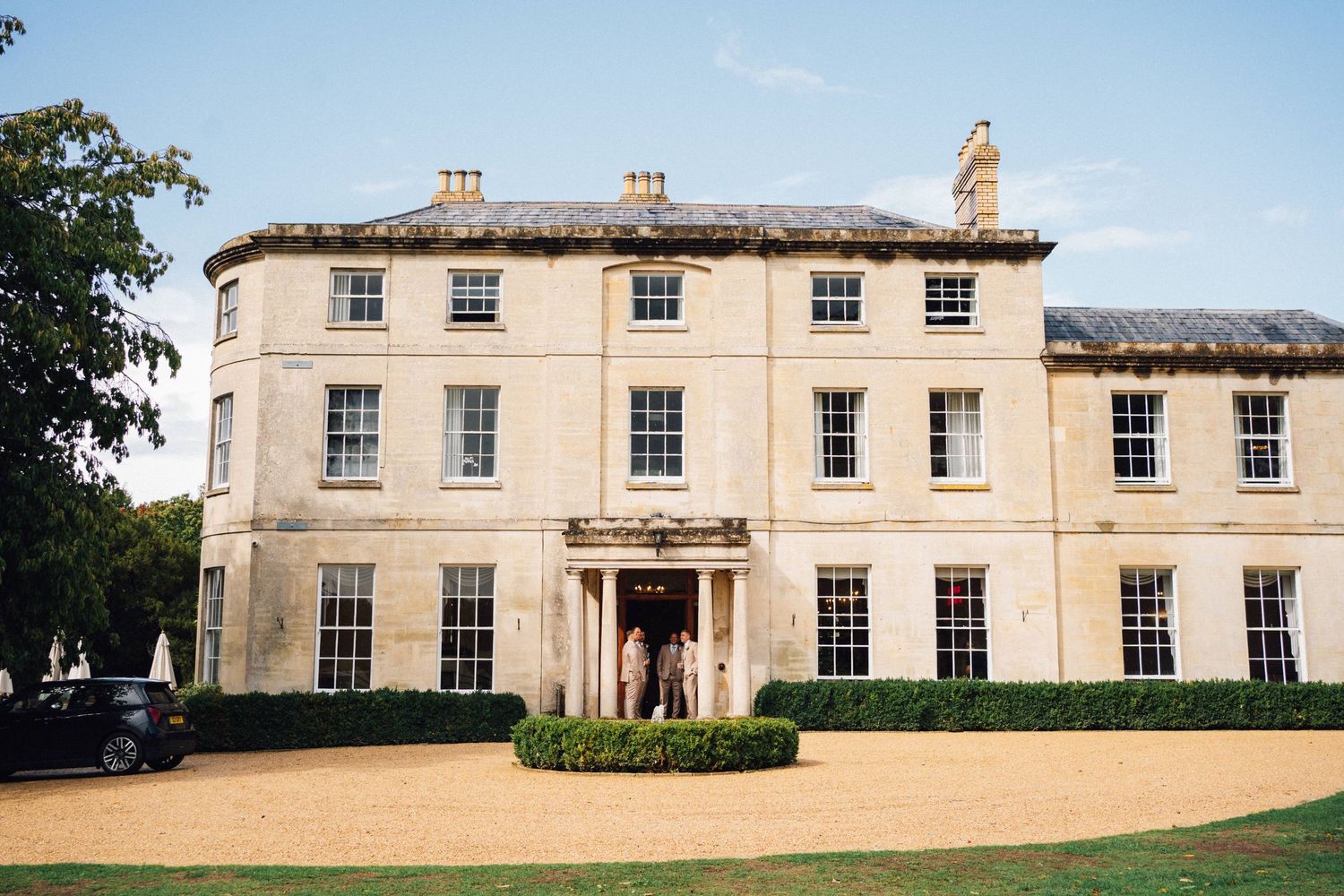 Elegant Georgian manor house with symmetrical windows and cream-colored facade shown from multiple exterior angles.