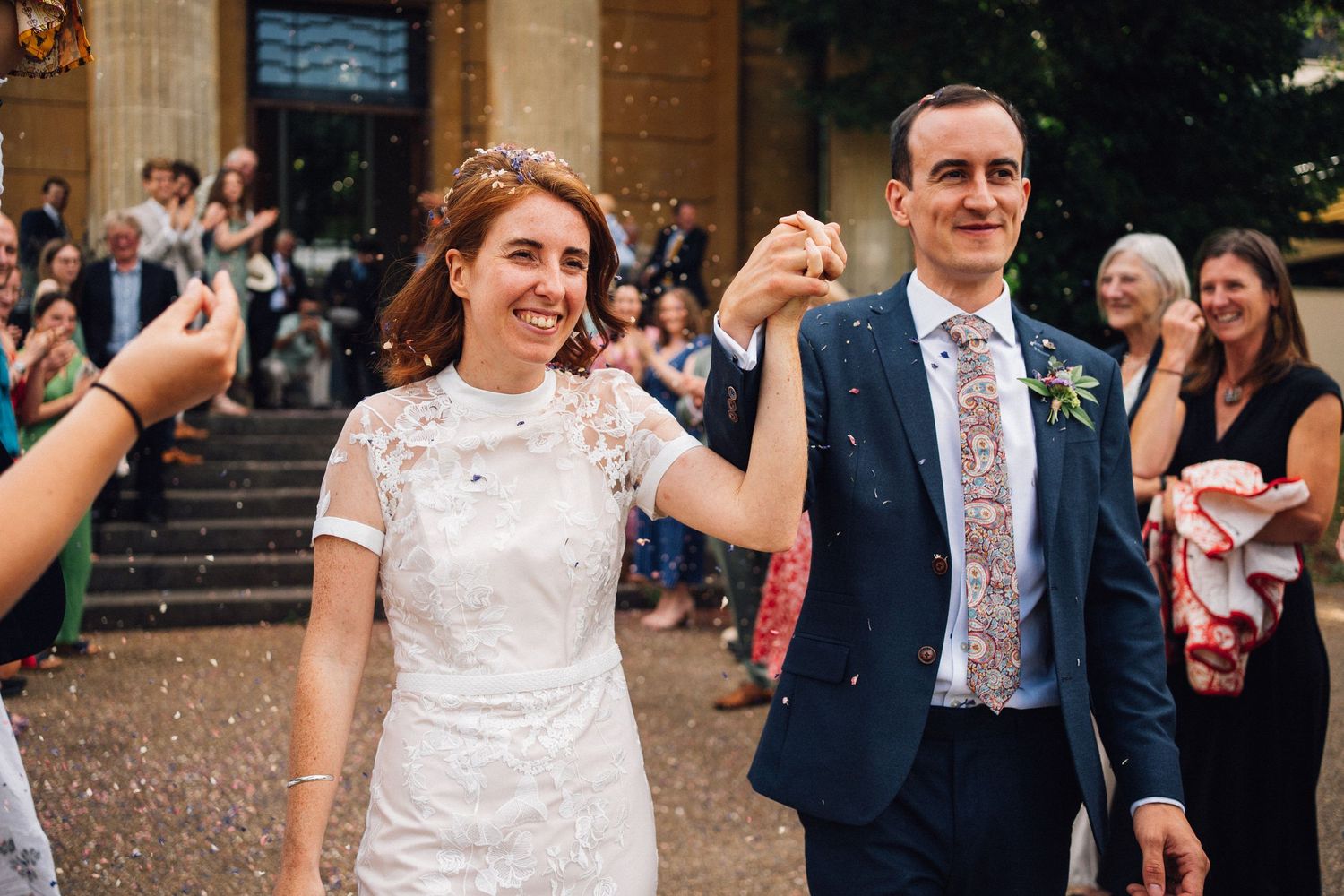 Wedding guests shower confetti on the newlyweds as they exit the church on their special day.