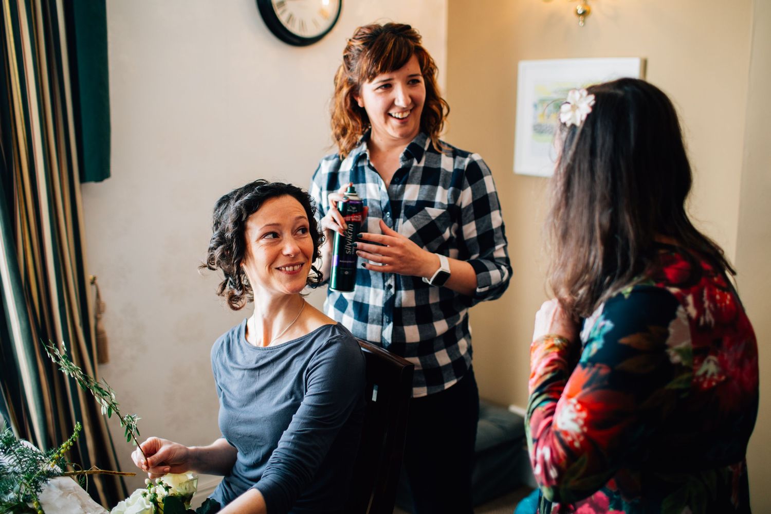 Group of friends sharing laughs and conversations in a cozy indoor setting.