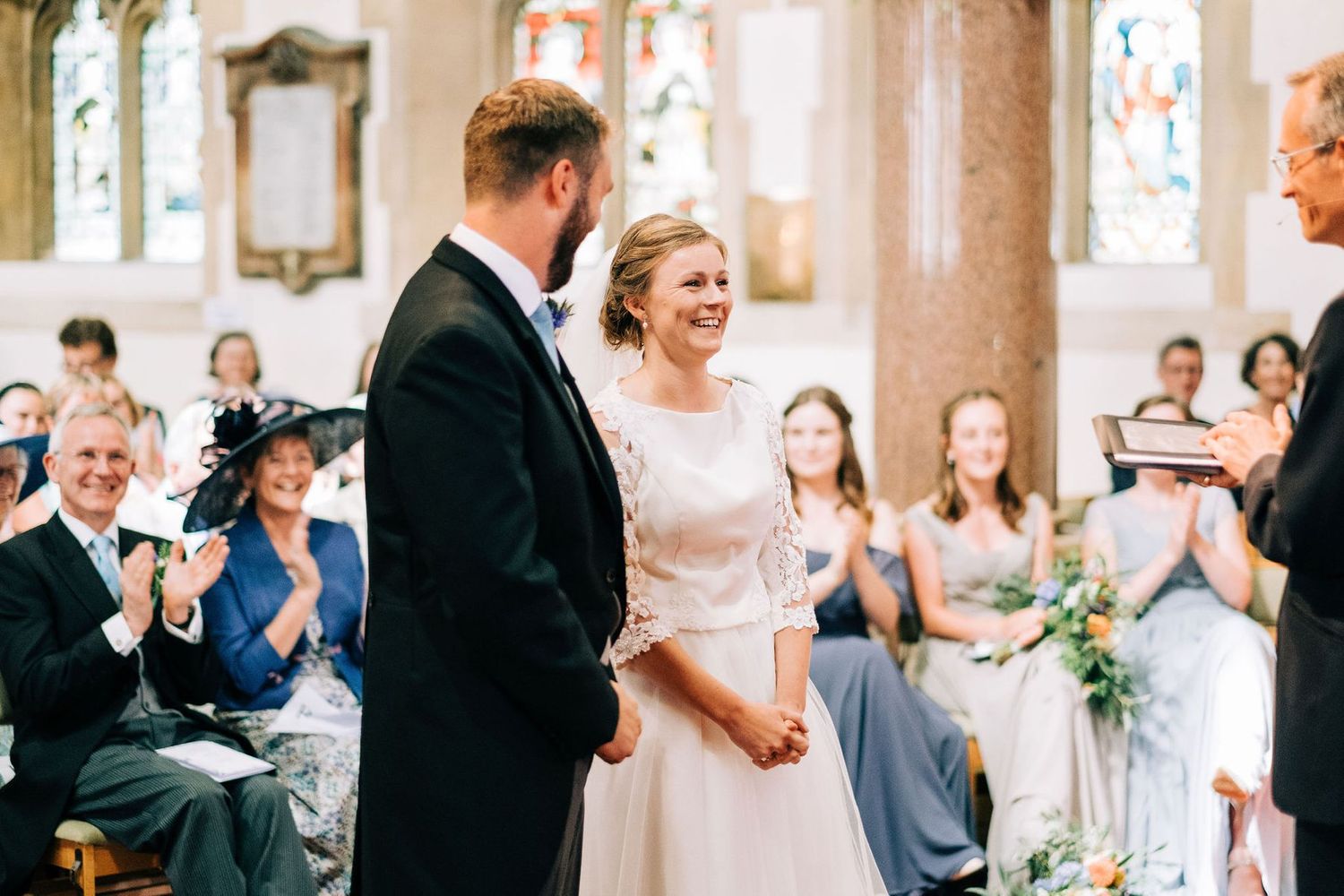 Emotional reactions and laughter during wedding ceremony in historic church.