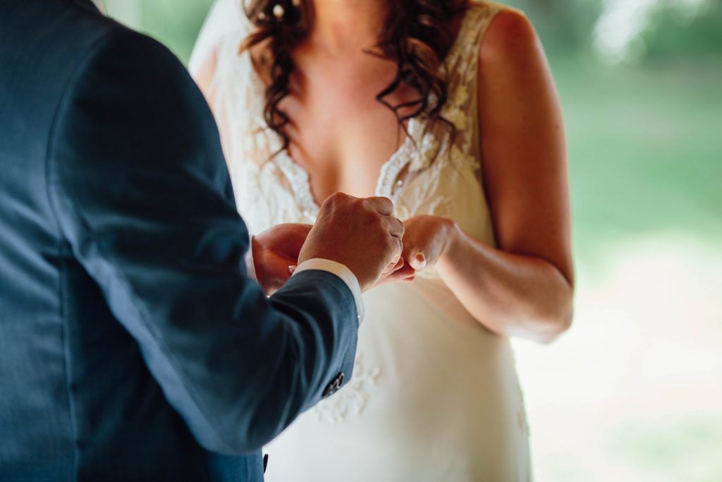 A couple shares their first dance at a wedding reception under soft lighting.