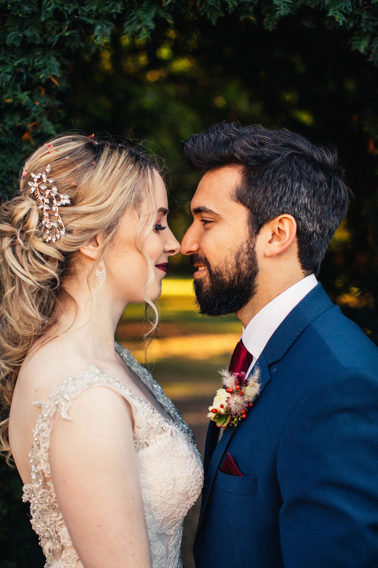 Intimate wedding portraits captured in natural garden setting with soft lighting.