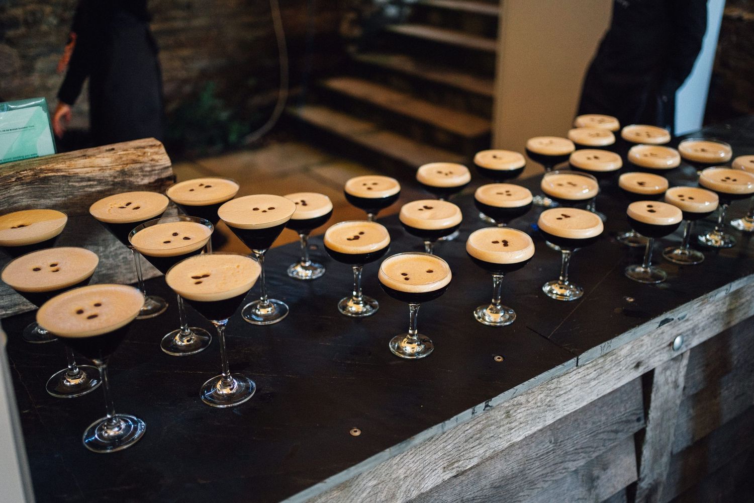 A collection of vintage wooden buttons arranged in rows on a dark surface shows their natural texture and patina.