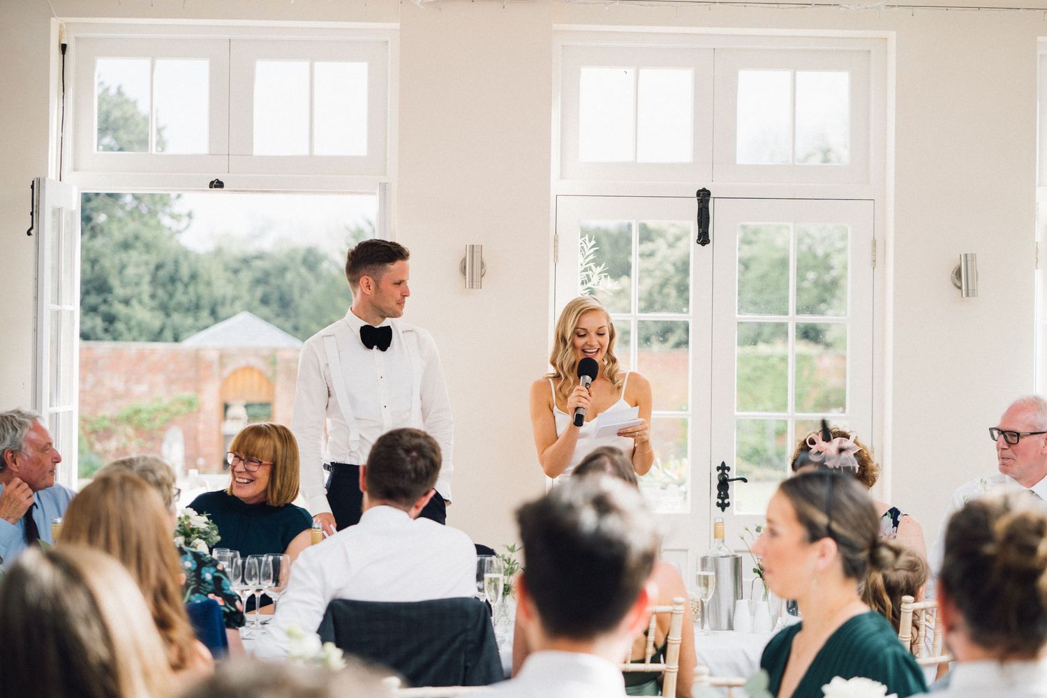 A series of wedding reception photos showing guests seated at tables and enjoying speeches during a celebration.