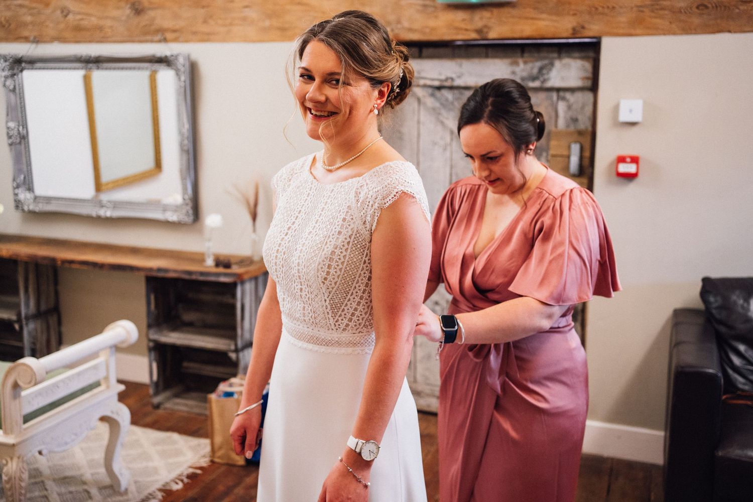 Bridal party making final preparations in a cozy getting-ready room.
