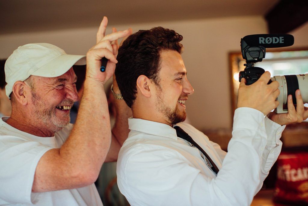 Group of people getting dressed and adjusting ties before an event.