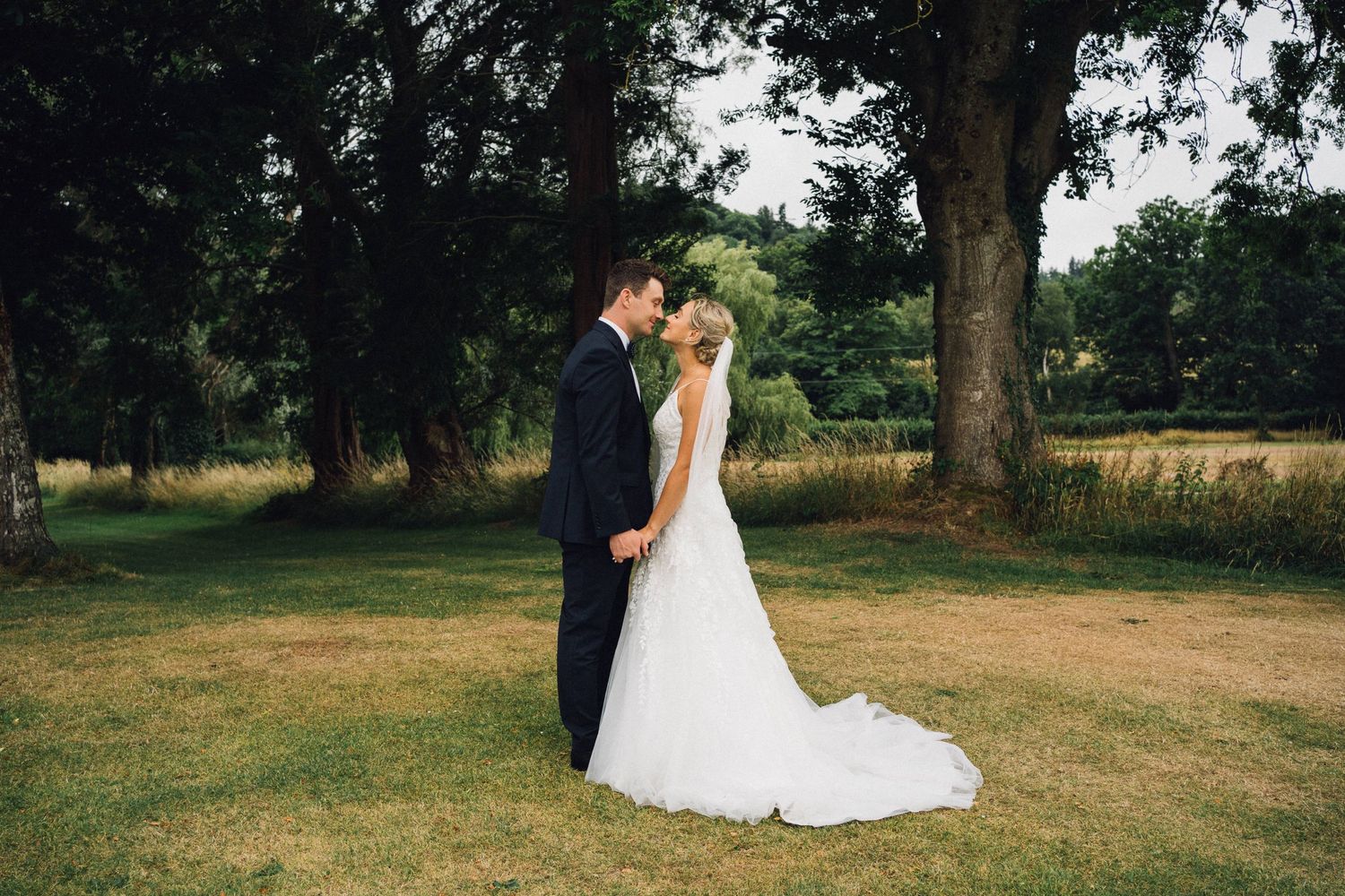 Intimate wedding couple portraits captured in a serene outdoor setting with natural lighting.