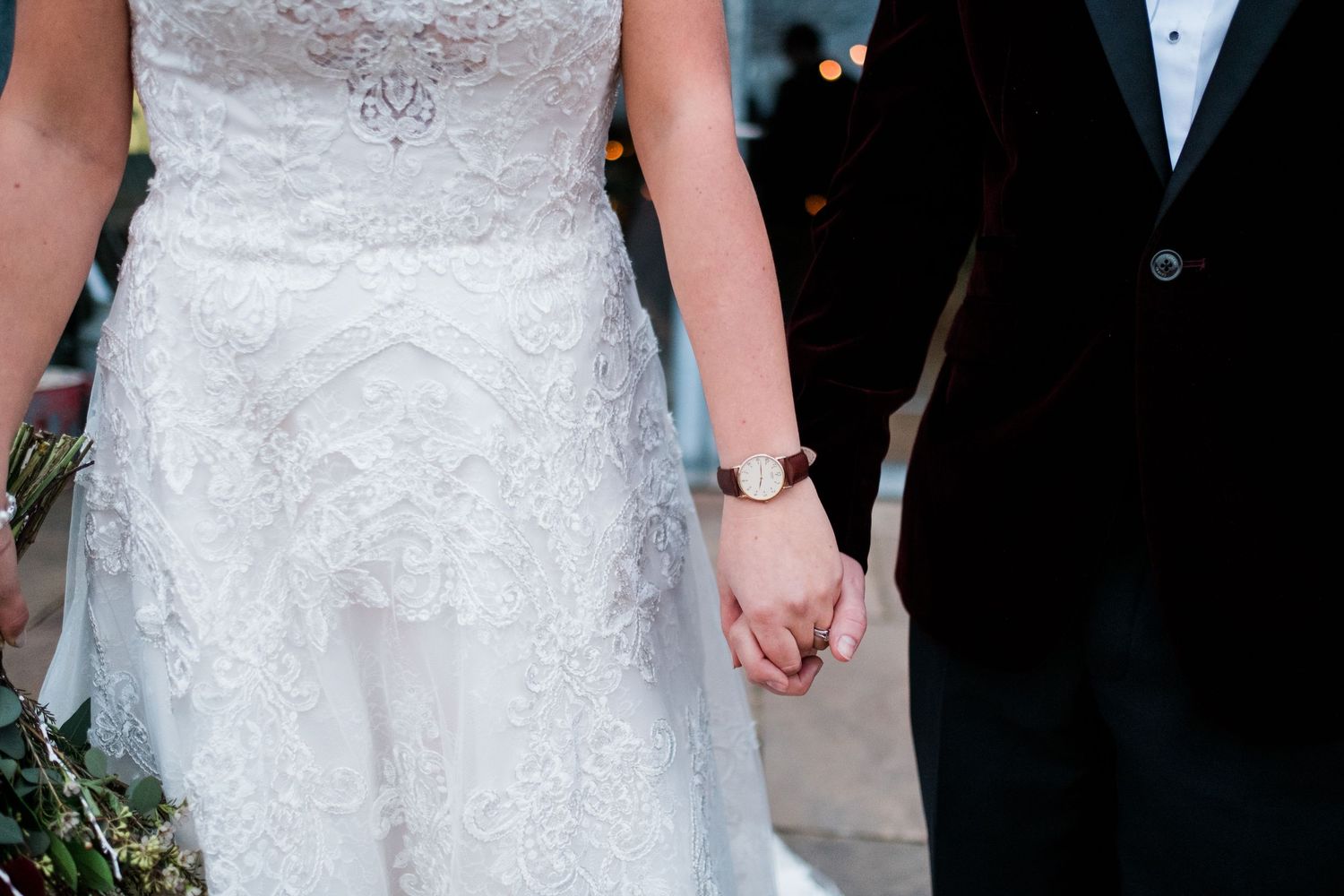 Elegant white wedding dresses and formal attire at an outdoor celebration.