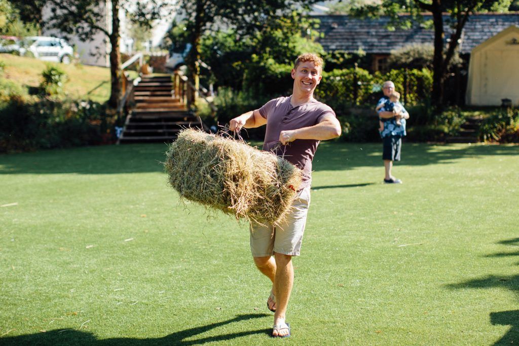 People playing lawn games and socializing on a sunny green field.