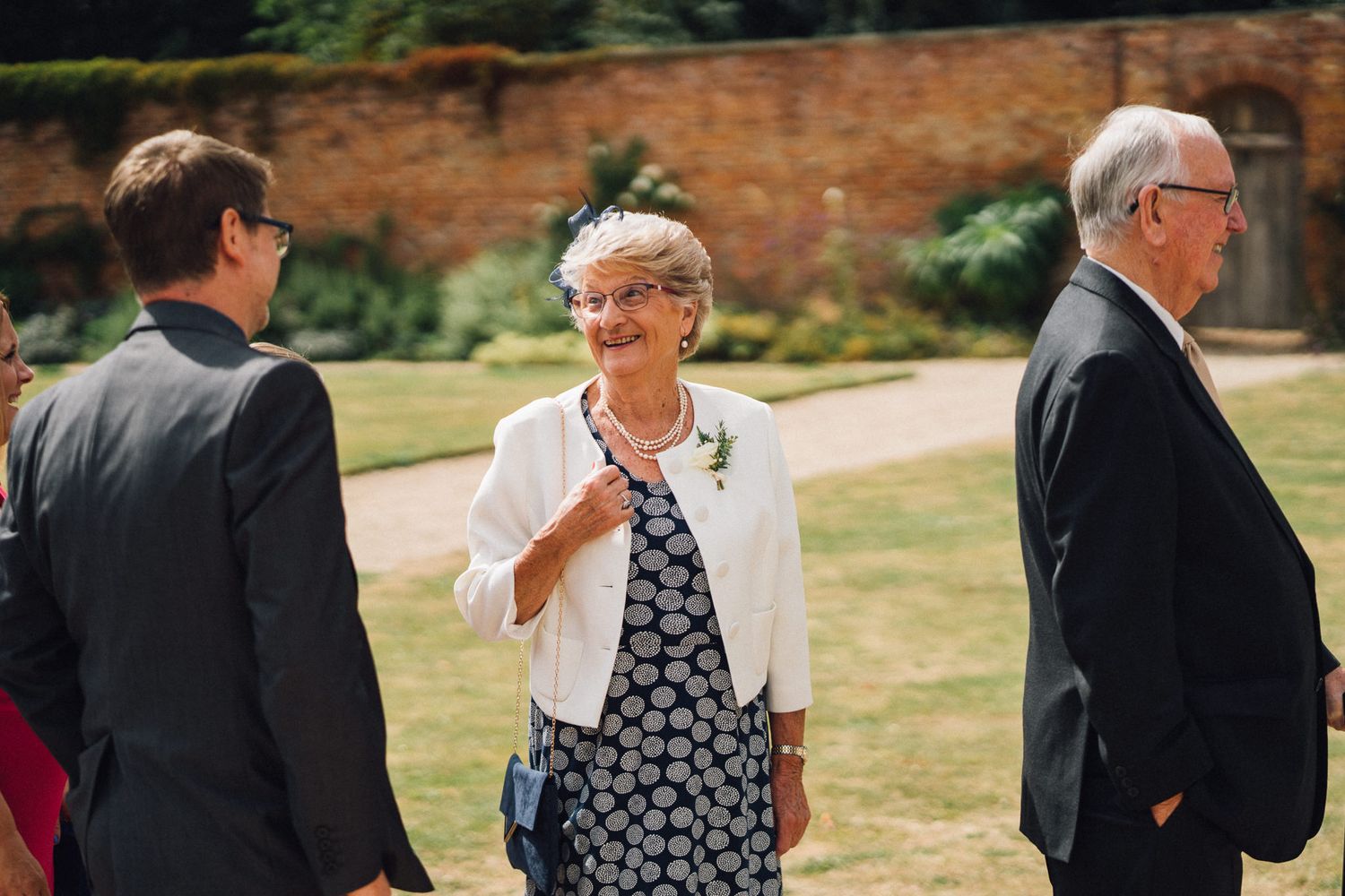 Guests chat and mingle during an elegant outdoor wedding reception.
