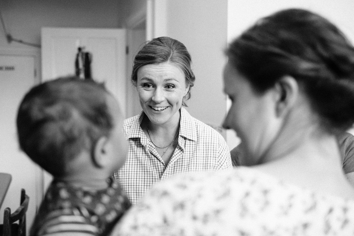 Black and white photo sequence showing joyful interactions during a special occasion.