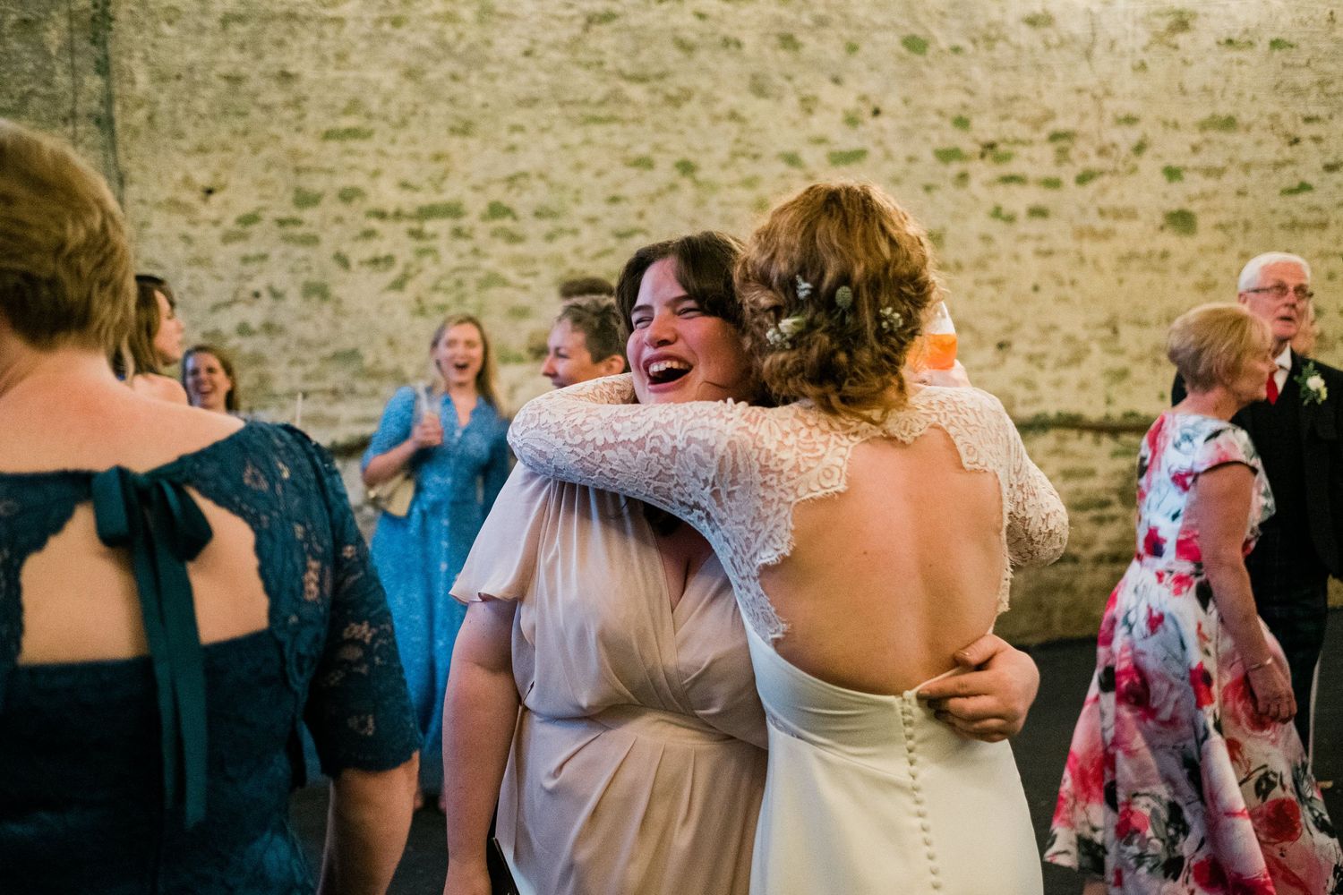 Wedding celebration with guests dancing and socializing on outdoor patio.