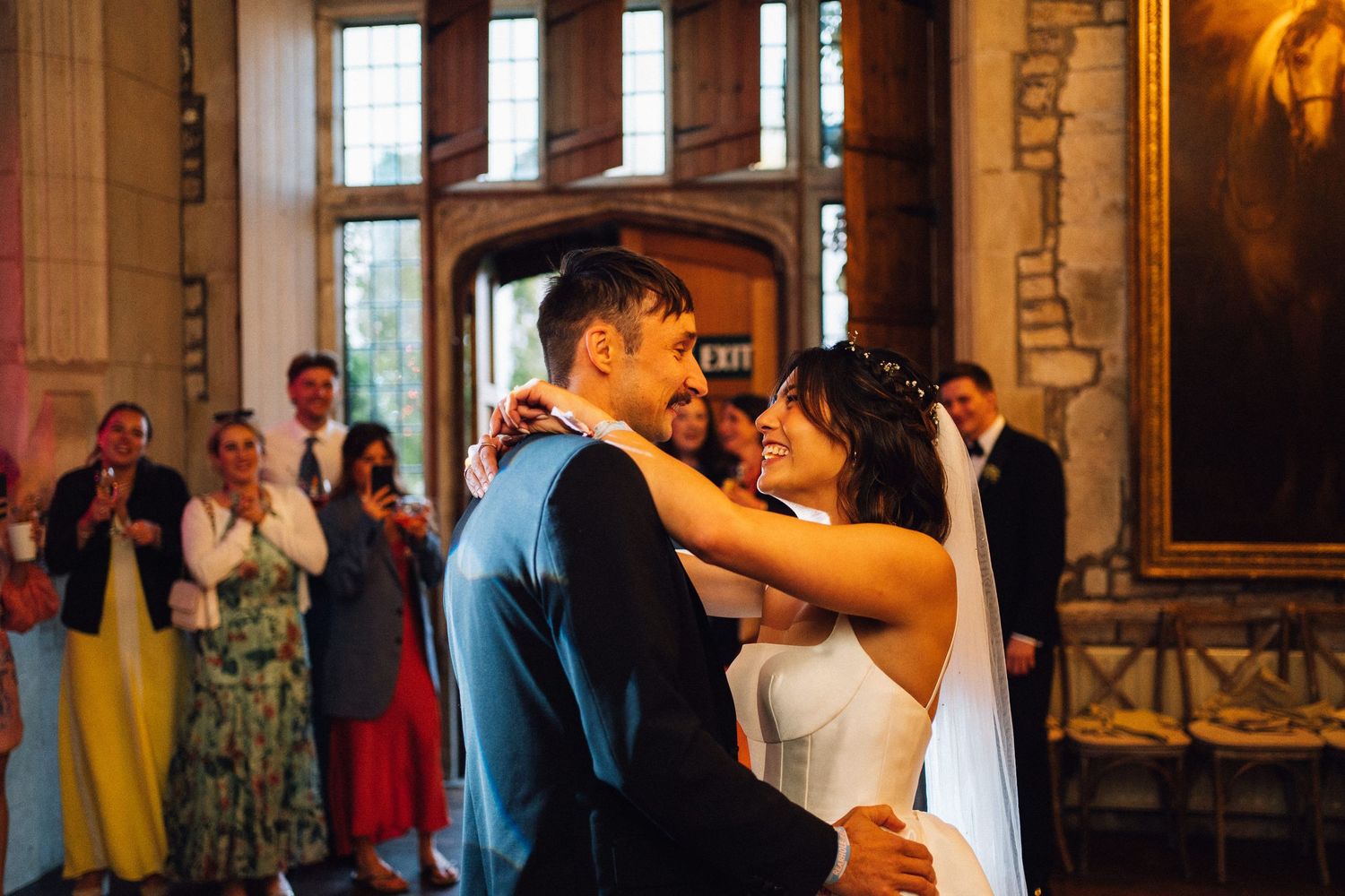Elegant indoor wedding reception venue with large windows and ornate architectural details.