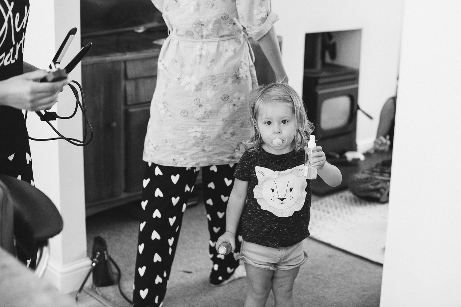 Black and white candid moments from wedding morning preparations.