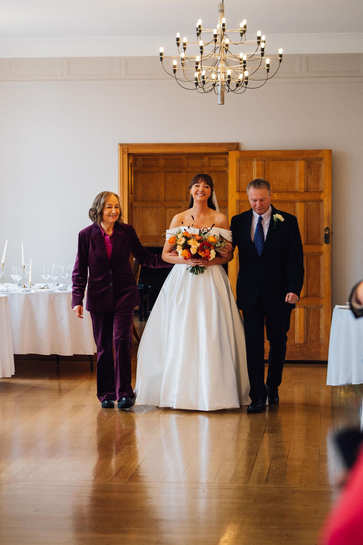 A sequence of wedding ceremony entrance photos showing a bride in white gown walking down a grand ballroom aisle.