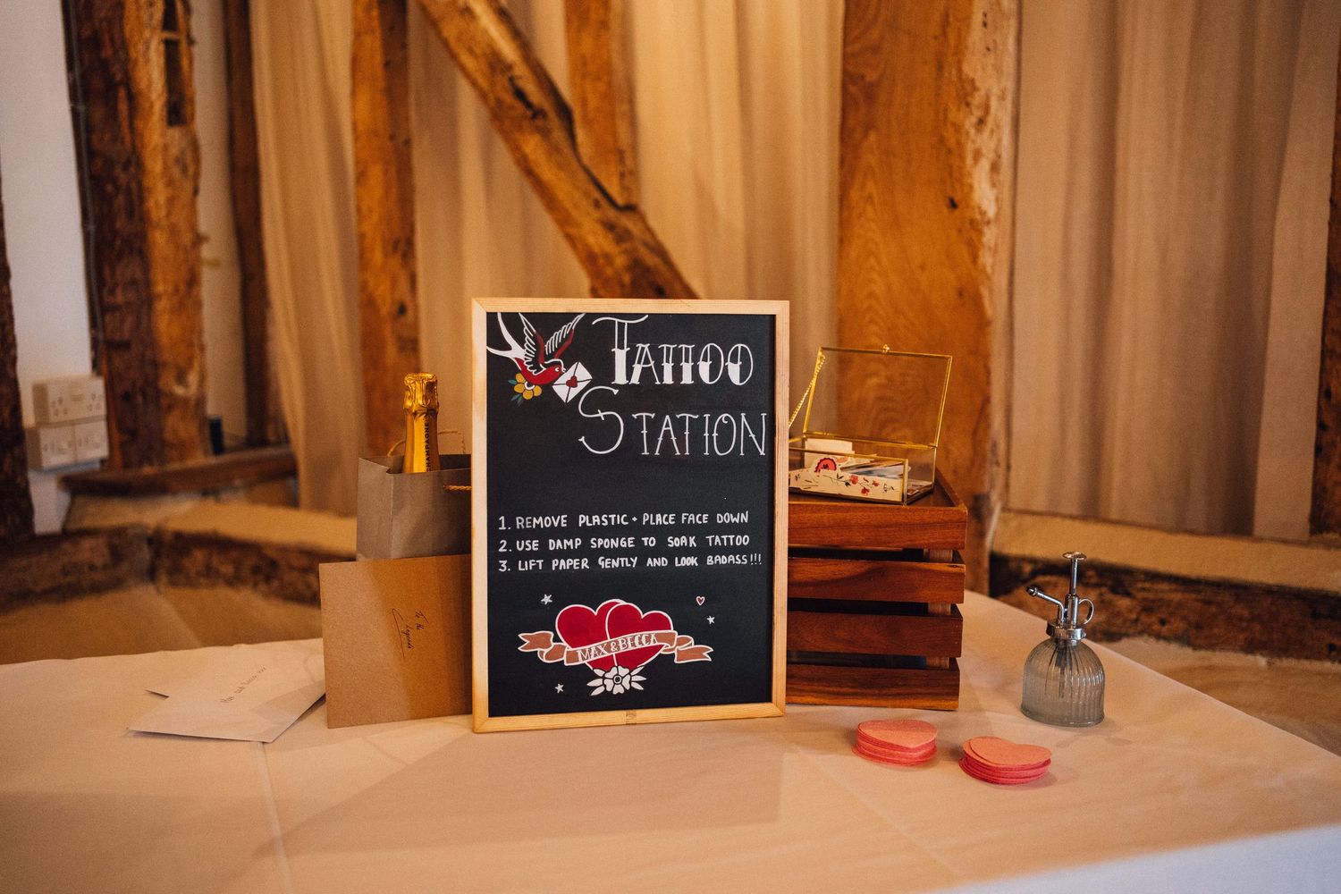 Elegant wedding venue interior with ornate decor and chalkboard signs displayed on antique tables.